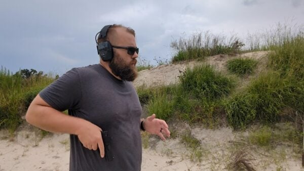 Shooter practicing handgun drills with a red dot pistol.