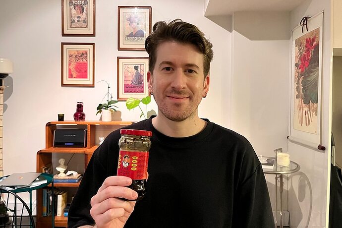 Jonathan holds a bottle of Lao Gan Ma